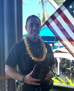 Kona Patrol Officer Charles Caldwell-Kaai holding his Officer of the Month award. 