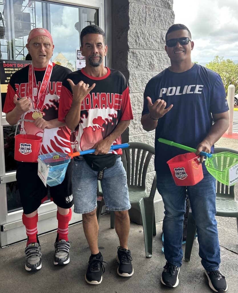 2 athletes & officer at Badges and Buckets fundraiser