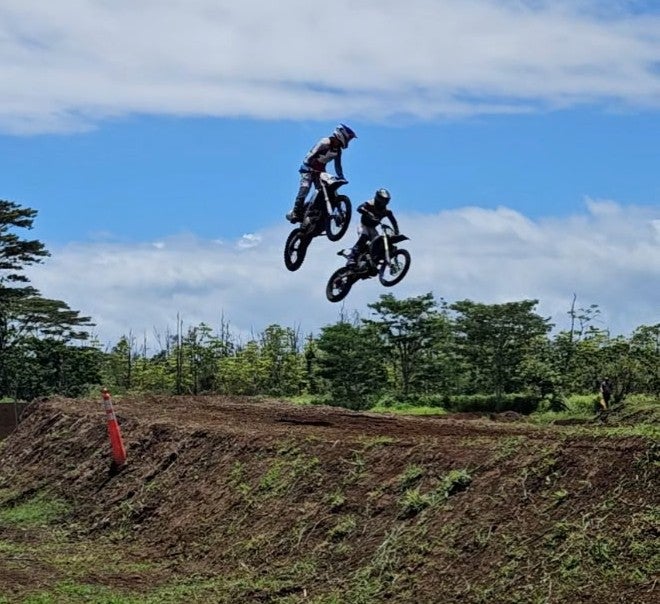 2 bikers airborne at HI-PAL Motocross event