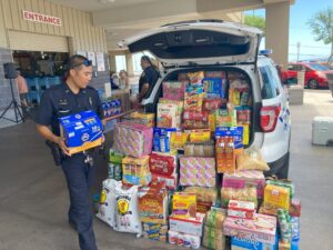 Police officer loading his cruiser with food