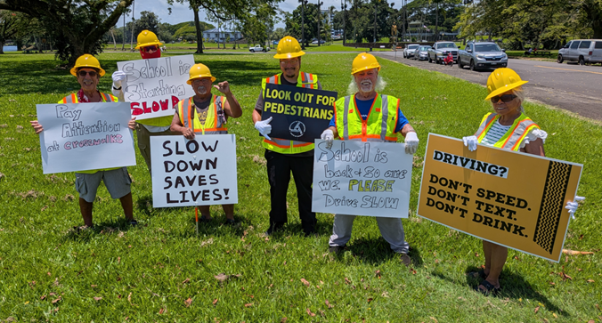 school crossing guards sign waving in Hilo.