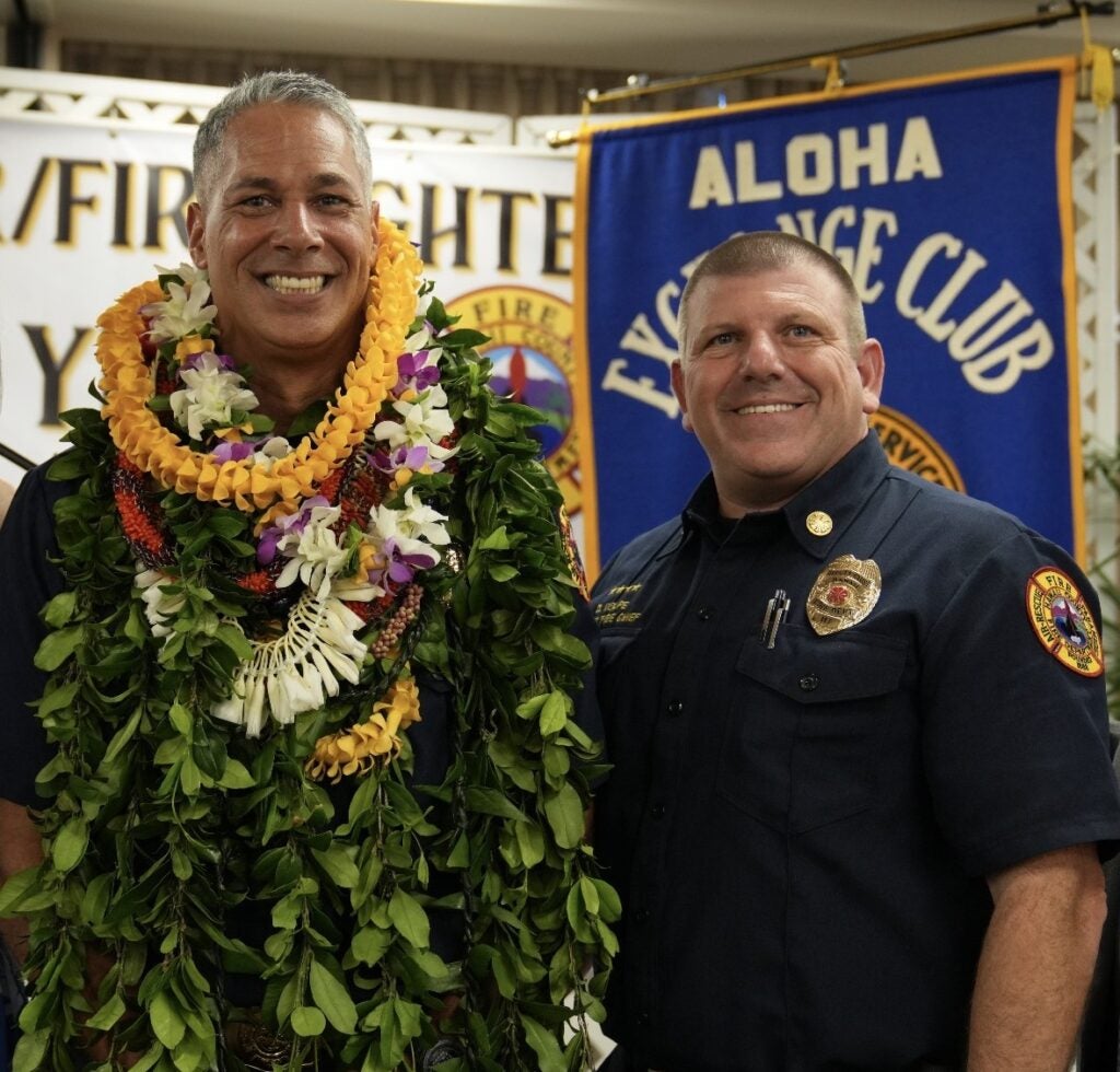 Hawaii Fire Department Battalion Chief Ka'Aina Keawe and Fire Chief Daniel Volpe smiling. 