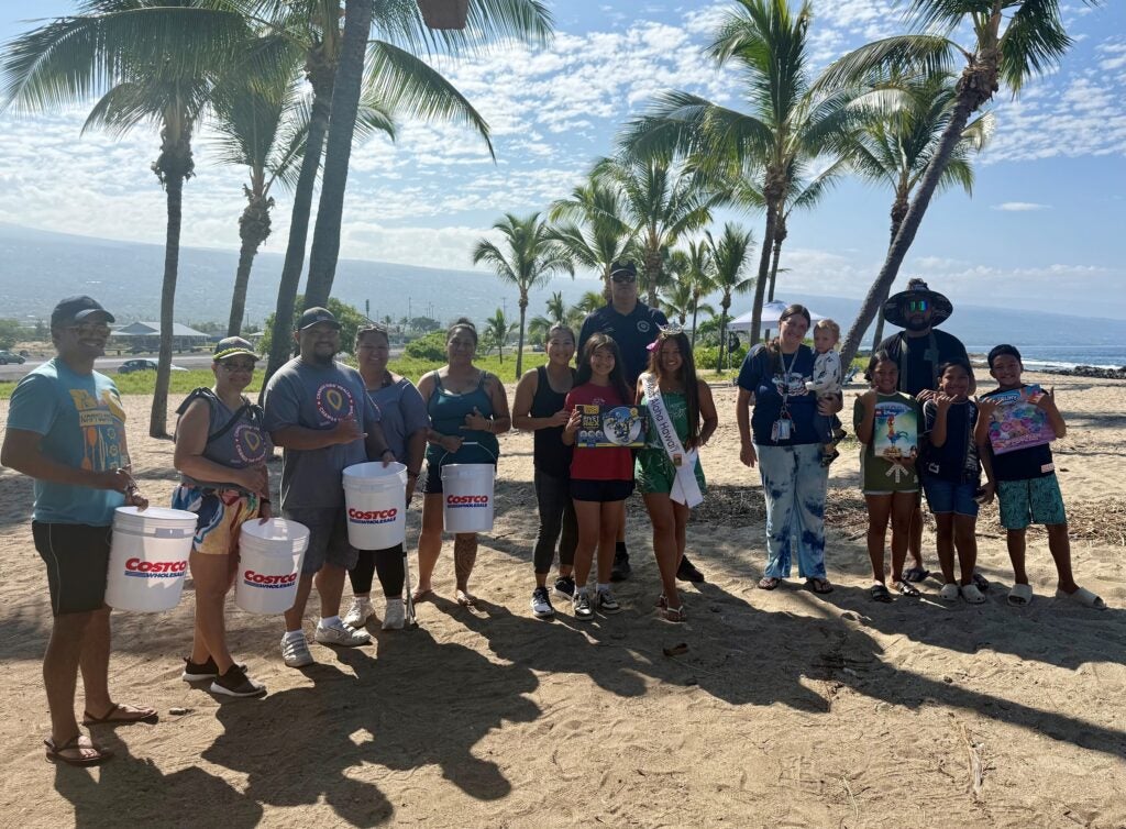 group photo with trash buckets at Beach Cleanup.