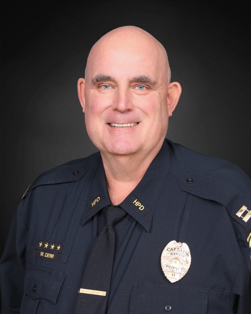 Captain William Derr in uniform against a black background.