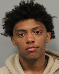 Deandre Moore, age 20, charged with eight firearms offenses.