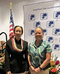 Detective Jenny Lee standing next to Deputy Chief Sherry Bird.