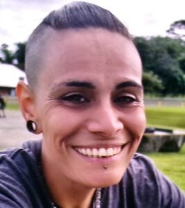 Georgiann Santos is described as a Hawaiian / Portuguese female with a medium brown complexion, approximately 5 feet 3 inches tall, weighing approximately 120 pounds, with brown eyes and medium length black hair with blonde tips. She has a tattoo of stars on her lower right forearm.