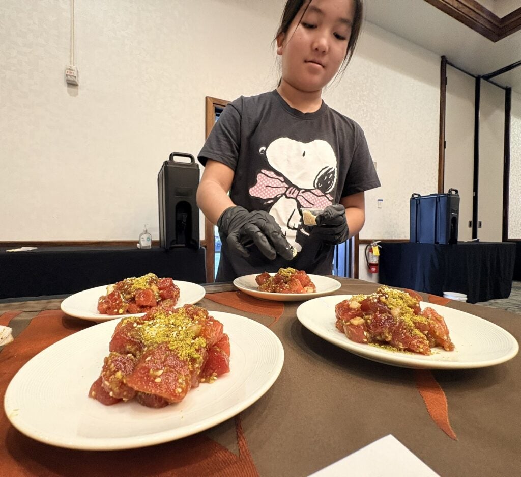 Girl garnishing her poke