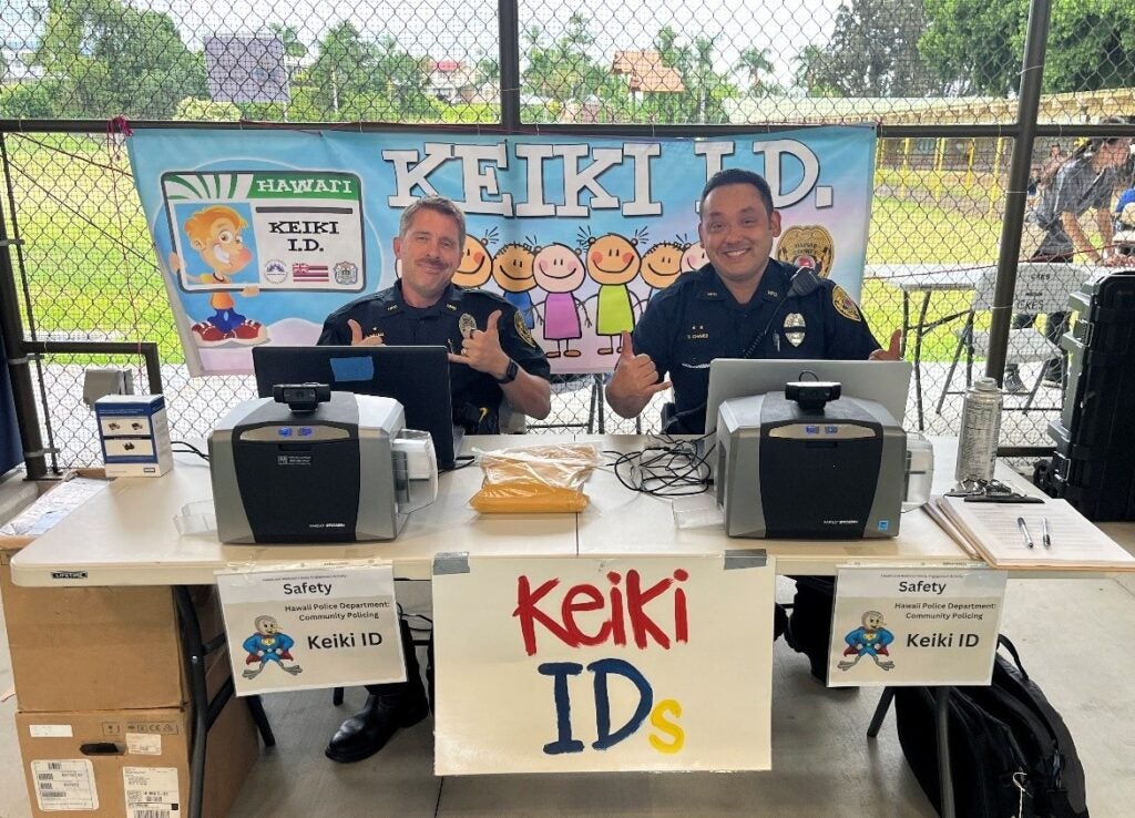 Two officers at Keiki ID booth.