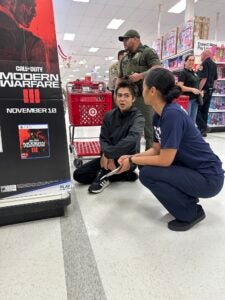 Female officer and child at Shop With a Cop event in Target store December 6, 2025. 