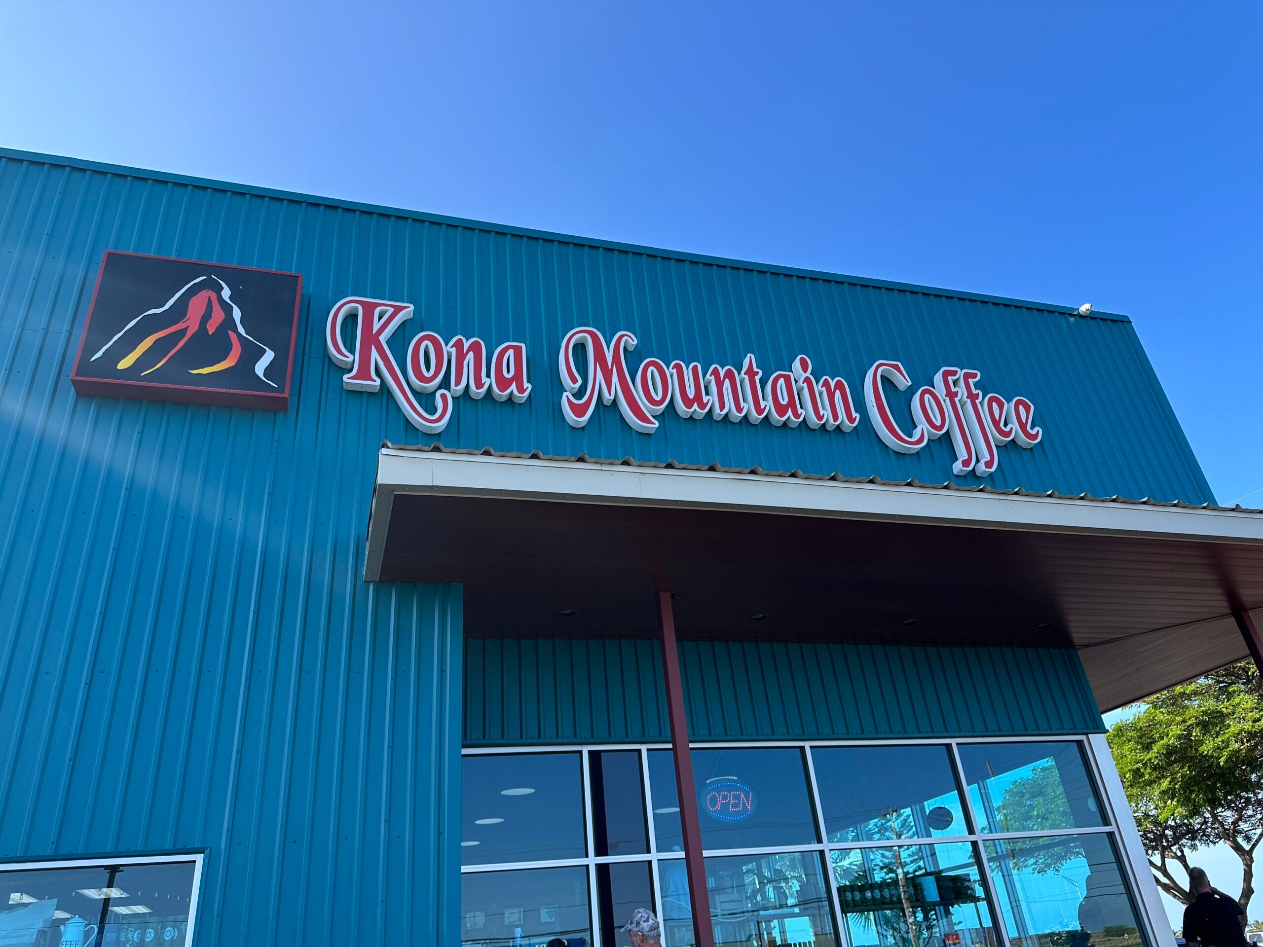 Kona Mountain Coffee Company sign on side of business.