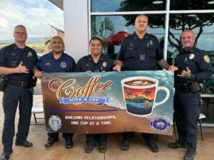 Kona Mountain Coffee with Officers holding banner
