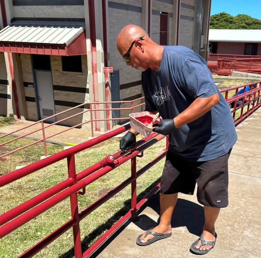 Man painting railing