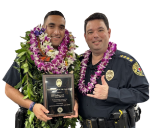 Officer of the Year Dallas Arce and Chief Reed Mahuna smiling.