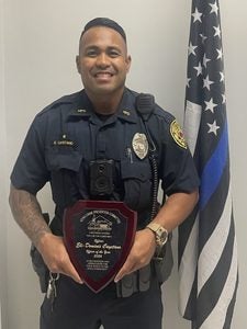 Kona Patrol Officer Eli-Dominic Cayetano holding his 2026 Kona Crime Prevention Committee Police Officer of the Year award.