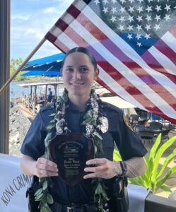 Officer Sarha Reich holding her award as as November Officer of the Month by Kona Crime Prevention Committee.