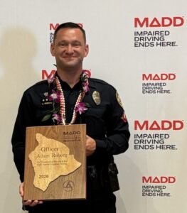Officer Adam Roberg holding his 2026 Mothers Against Drunk Driving (MADD) Award.
