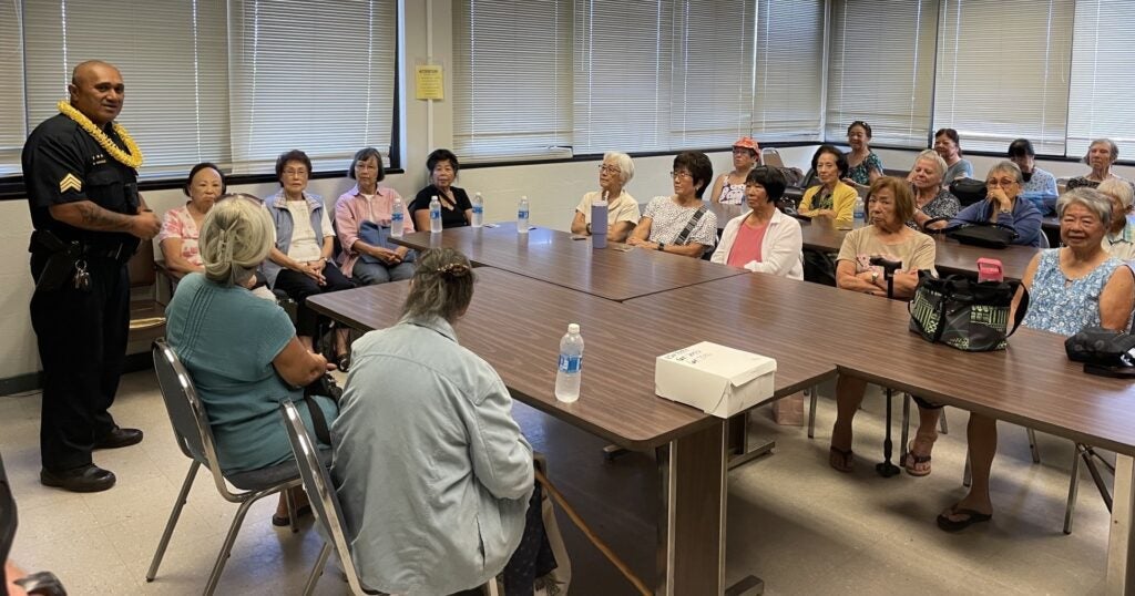 Sergeant Nahale speaking to room of seniors during Kupuna Day.