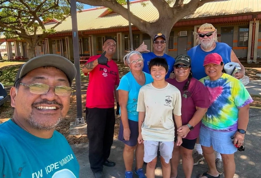 Group photo of volunteers at school beautification project.