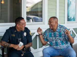 Officer laughing with man at Coffee With a Cop event.