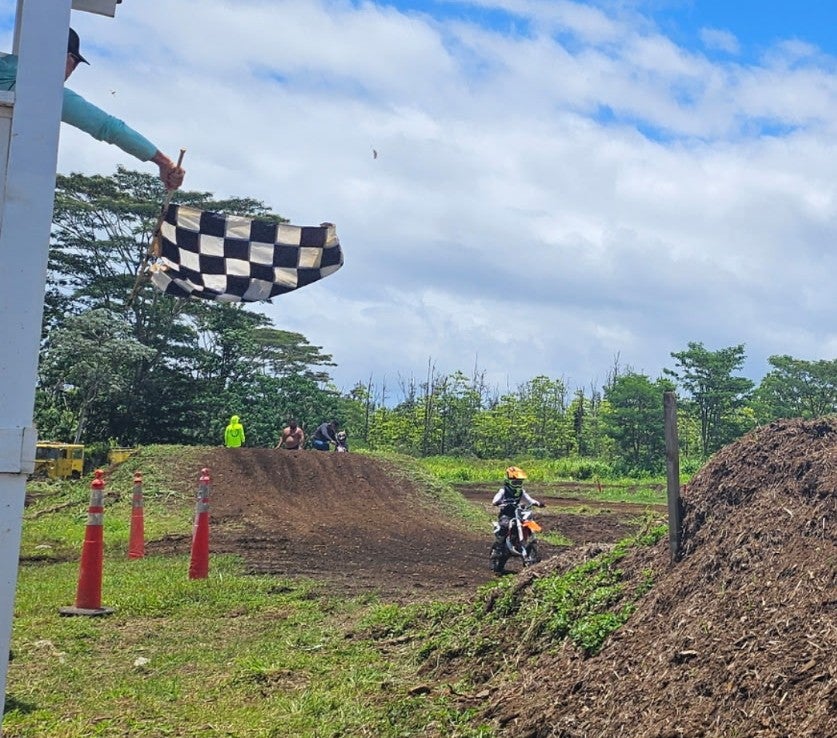 checkered flag waving at dirtbiker during HI-PAL Motocross event