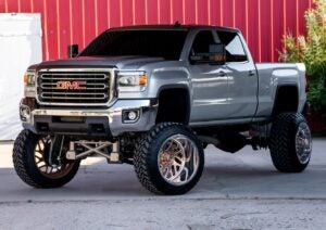 lifted pickup truck with dark tinted windows.