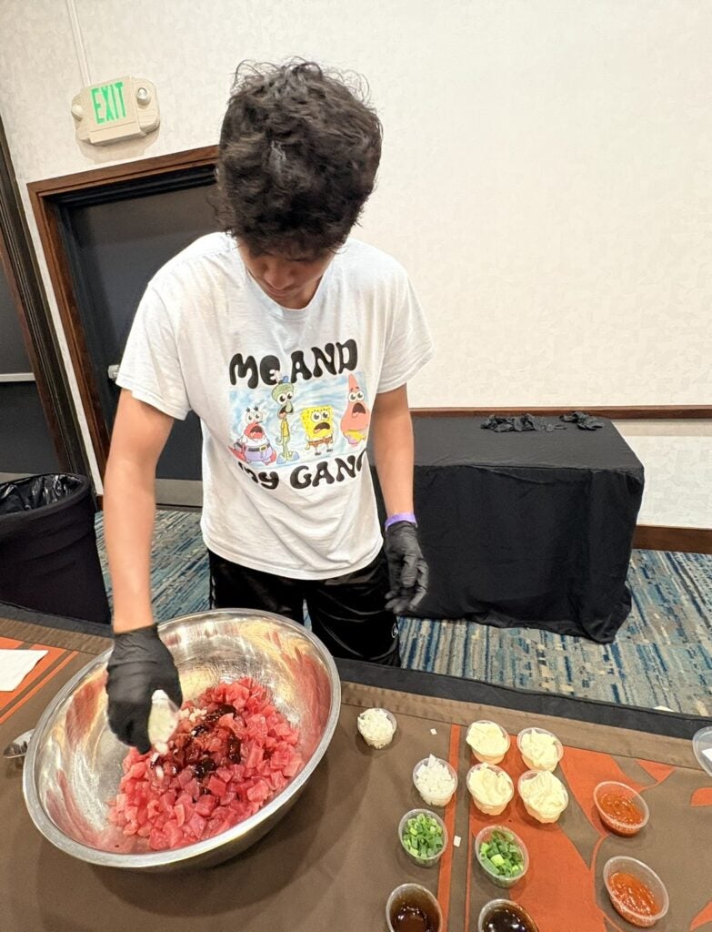 teen boy making poke