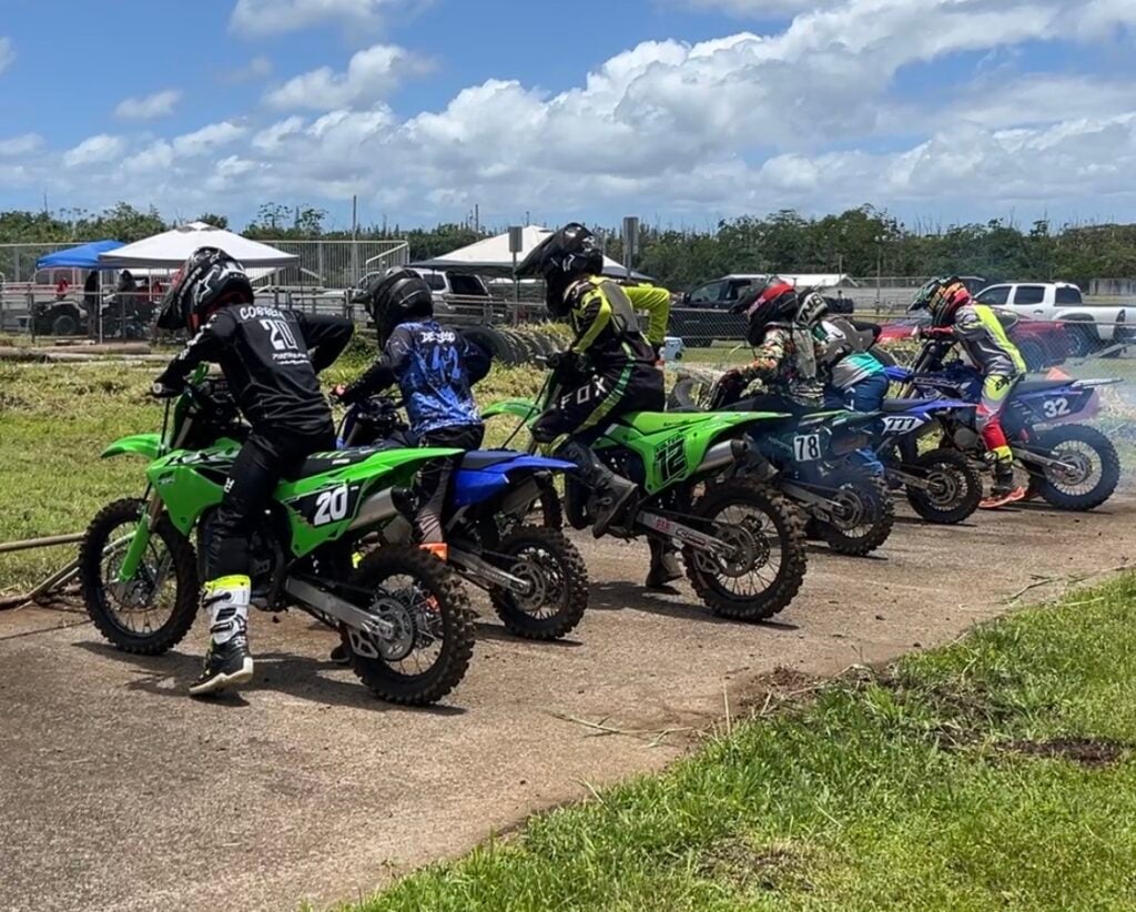 Teen riders at starting line of motocross event.