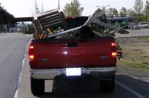 Uncovered load in bed of red pickup truck.